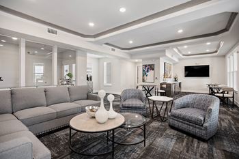 the living room of a new home with couches and chairs at Ellis Station, Durham